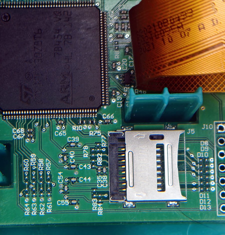 Close-up of the Lunii board: the microSD socket next to the ST ARM microcontroller