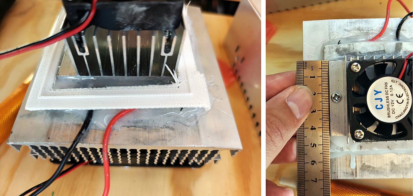 A white printed frame on the Peltier kit, and a ruler measuring the cold plate and fan